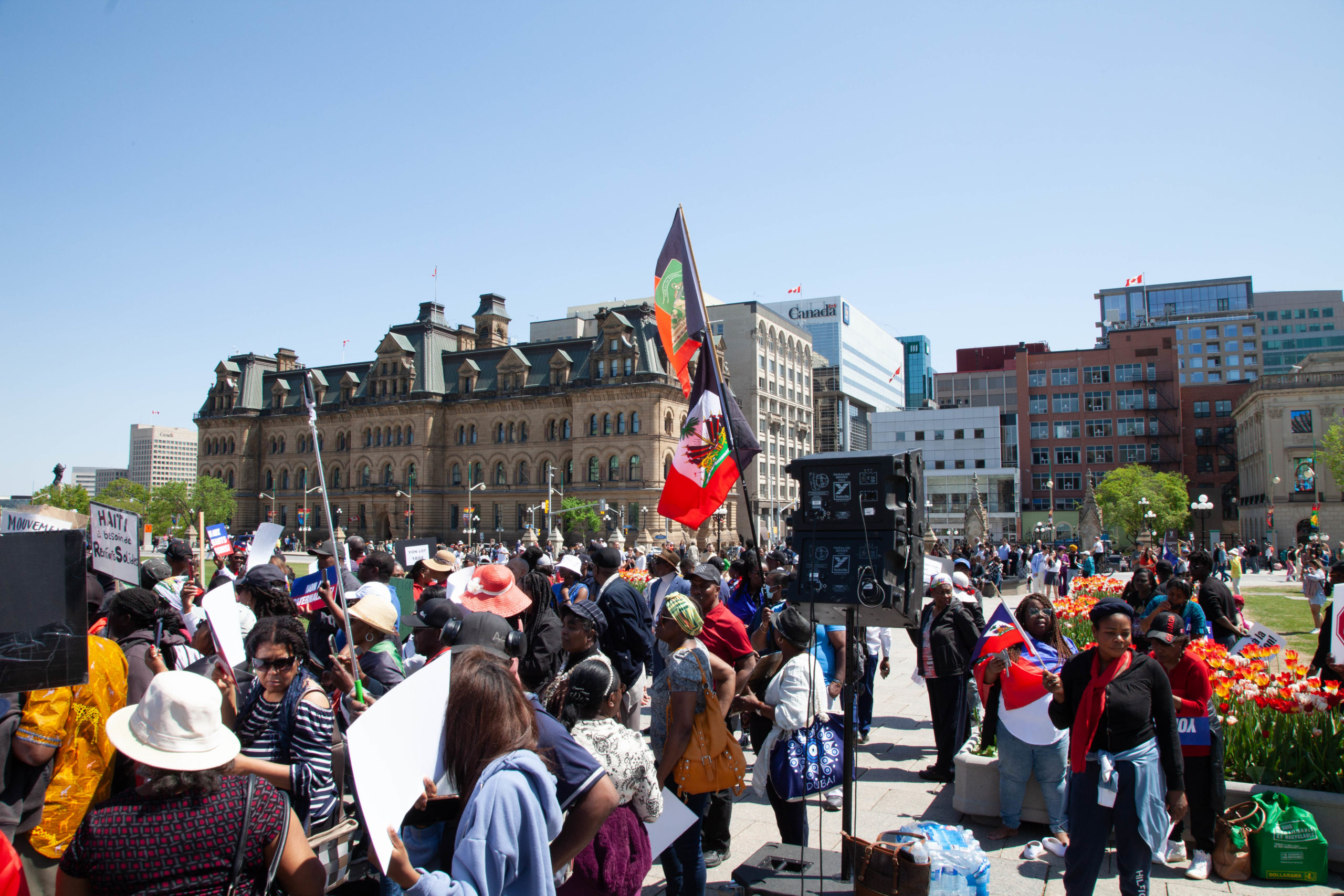 People are raising the Haitian flag.